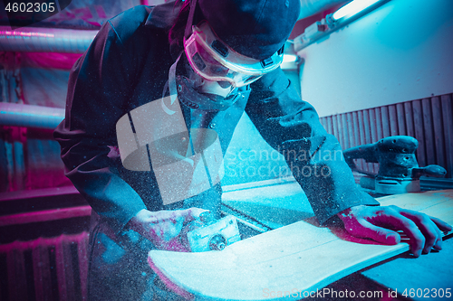 Image of Skater in process of making his own skateboard, longboard - open business concept