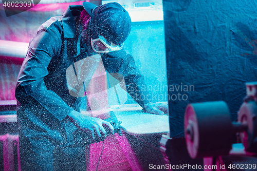 Image of Skater in process of making his own skateboard, longboard - open business concept