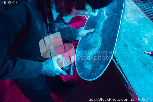 Image of Skater in process of making his own skateboard, longboard - open business concept