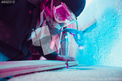 Image of Skater in process of making his own skateboard, longboard - open business concept