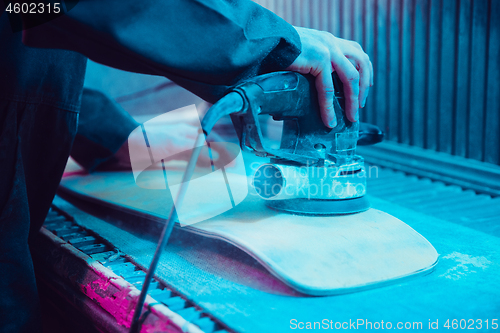 Image of Skater in process of making his own skateboard, longboard - open business concept