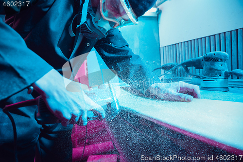 Image of Skater in process of making his own skateboard, longboard - open business concept