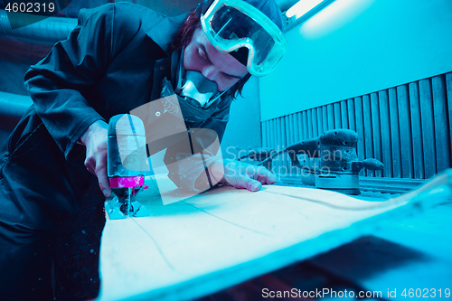 Image of Skater in process of making his own skateboard, longboard - open business concept