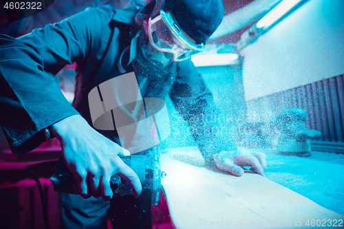 Image of Skater in process of making his own skateboard, longboard - open business concept