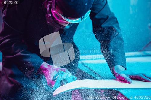 Image of Skater in process of making his own skateboard, longboard - open business concept