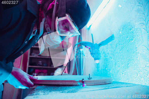 Image of Skater in process of making his own skateboard, longboard - open business concept