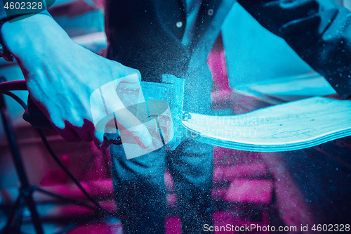 Image of Skater in process of making his own skateboard, longboard - open business concept