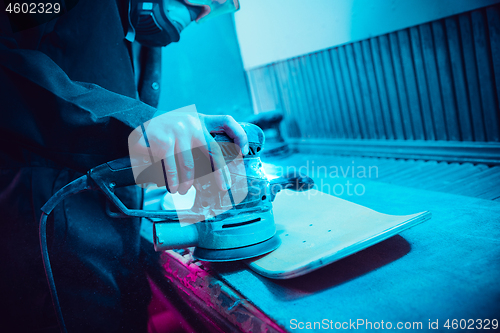 Image of Skater in process of making his own skateboard, longboard - open business concept