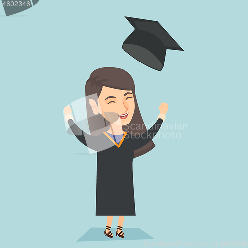 Image of Caucasian graduate throwing up graduation hat.