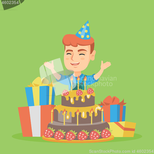 Image of Little caucasian boy jumping out of a large cake.