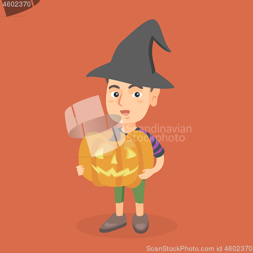 Image of Young boy holding a carved pumpkin for Halloween.