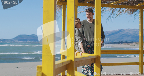 Image of Couple chating and having fun at beach bar