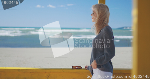 Image of Young woman enjoying the warm autumn day