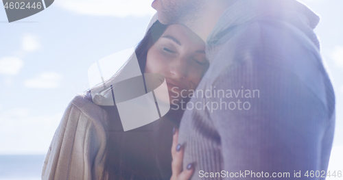 Image of Couple having fun on beautiful autumn day at beach