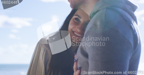 Image of Couple having fun on beautiful autumn day at beach