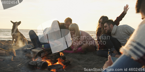 Image of Friends Relaxing At Bonfire Beach Party