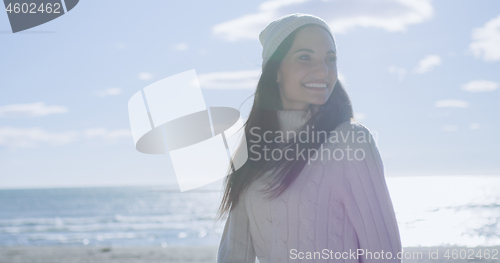 Image of Girl In Autumn Clothes Smiling on beach