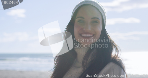 Image of Girl In Autumn Clothes Smiling on beach