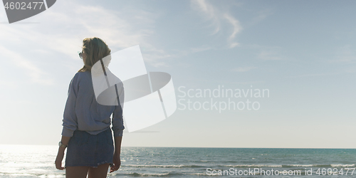 Image of Young woman enjoying the warm autumn day