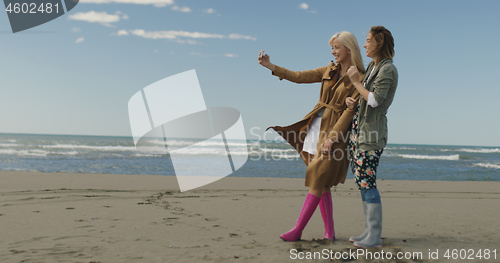 Image of Girls having time and taking selfie on a beach