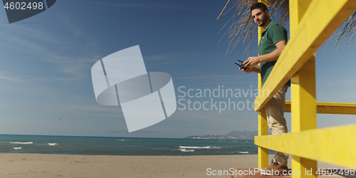 Image of Man Operating Drone By The Sea