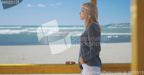 Image of Young woman enjoying the warm autumn day