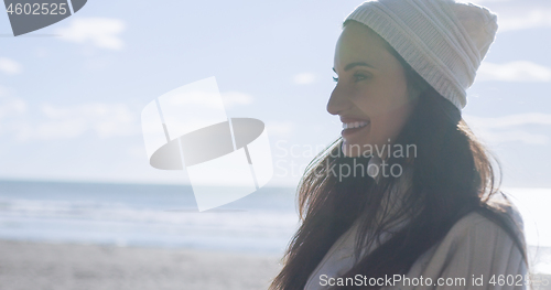 Image of Girl In Autumn Clothes Smiling on beach