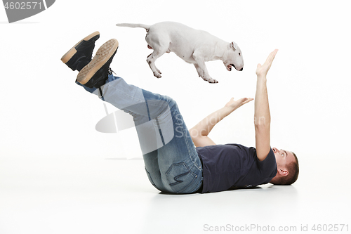 Image of Emotional Portrait of a man and his Bull Terrier dog, concept of friendship and care of man and animal