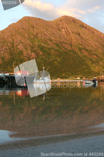 Image of Fishing boats and mountain.