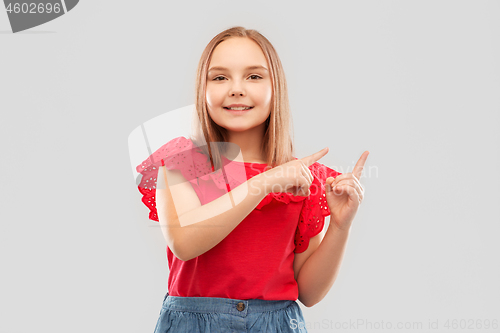 Image of smiling girl pointing fingers to something