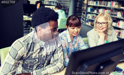 Image of international students with computers at library