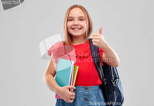 Image of student girl with books and bag showing thumbs up