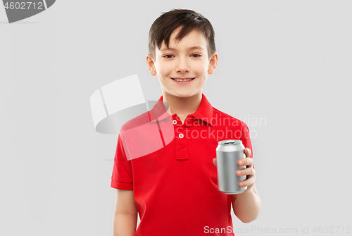 Image of boy in red t-shirt drinking soda from tin can