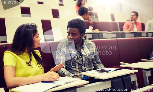 Image of group of students with notebooks at lecture hall