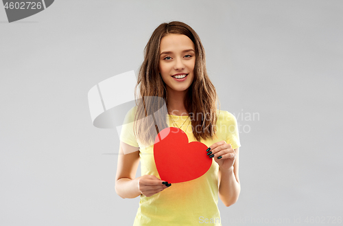 Image of smiling teenage girl with red heart