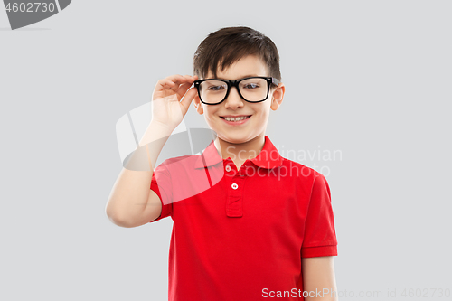 Image of portrait of smiling boy in glasses and red t-shirt