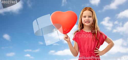 Image of happy red girl with heart shaped balloon over sky