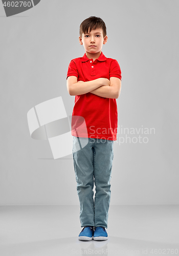 Image of sad boy in red polo t-shirt with crossed arms