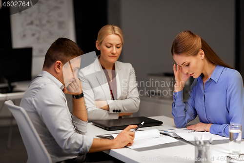 Image of business team with laptop working at night office