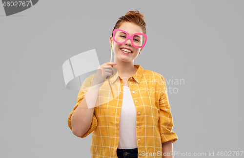 Image of smiling red haired teenage girl with big glasses
