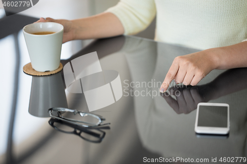 Image of woman with coffee using black interactive panel