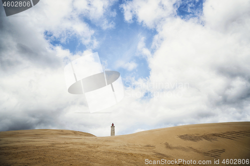 Image of Lighthouse tower rising up on a dune beach