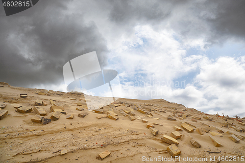 Image of Bricks in the sand left remains of a building