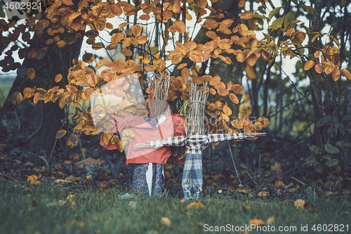 Image of Scarecrows in a garden in the fall