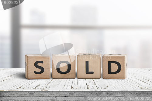 Image of Sold sign on a wooden table
