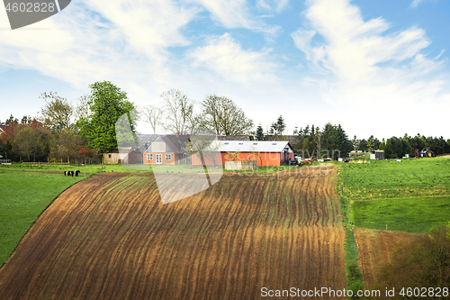 Image of Farm on the top of a hill with cultivated fields