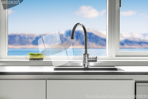 Image of Kitchen sink by a window with a view