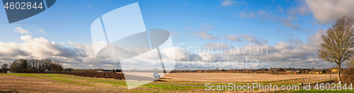 Image of Tractor in a rural panorama landscape