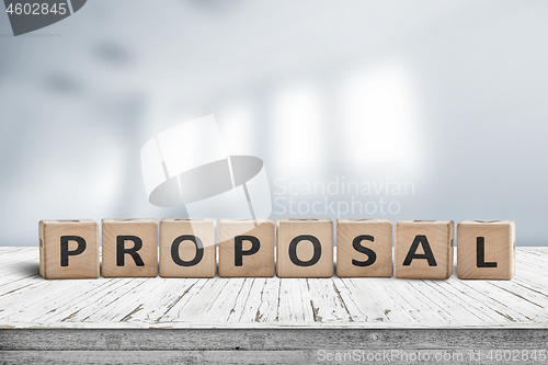 Image of Proposal sign on a wooden desk in a bright office