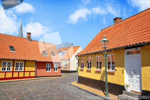 Image of Street with yellow buildings and cooblestone